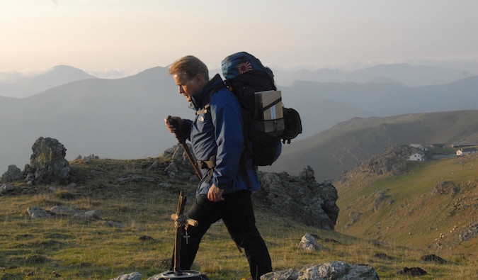 old man hiking in the way