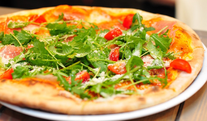 Close up of a New York pizza with vegetable toppings