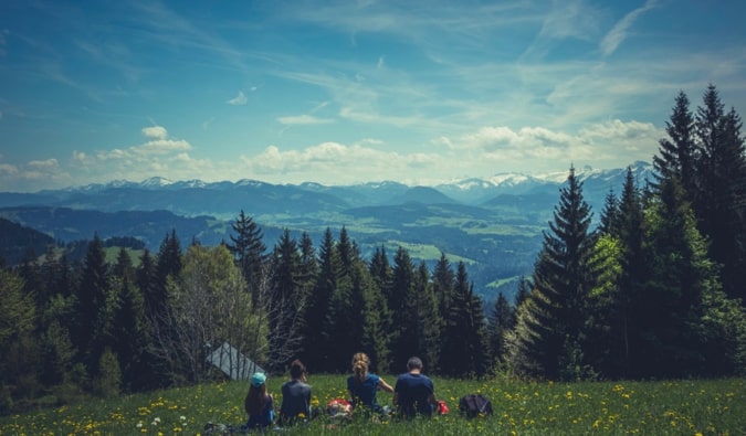 A group of travelers relaxing in a field after a long hike