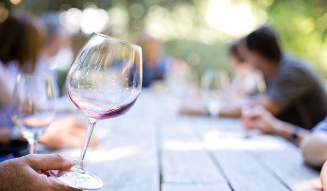 Drinking wine with friends at a picnic table in New Zealand