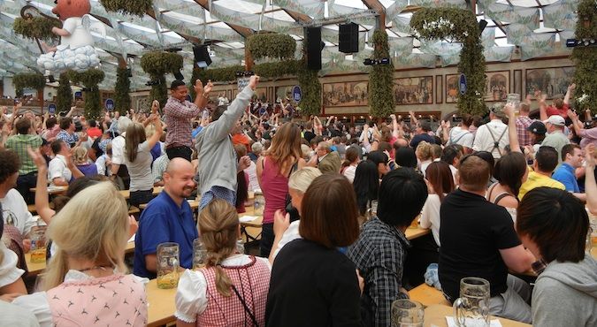 Nomadic Matt celebrating Oktoberfest inwards Federal Republic of Federal Republic of Germany amongst many beers How to Survive Oktoberfest