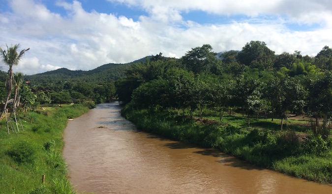 A dark brown river flowing near Pai, Thailand