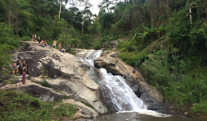 Backpackers visiting one of the many waterfalls near Pai, Thailand