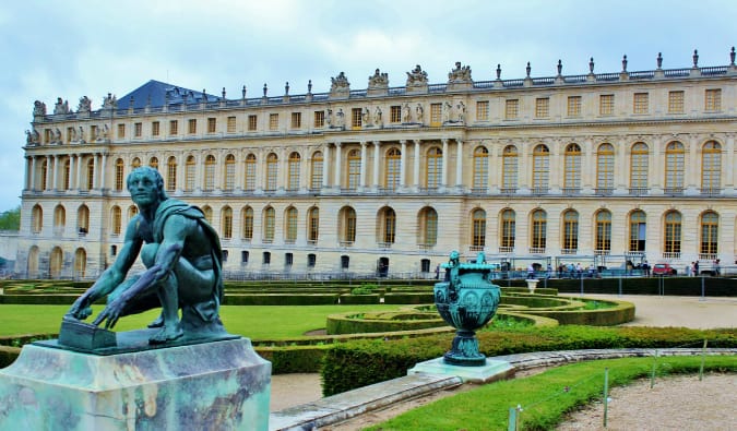 The statues and beautiful facade of the Palace of Versailles in France