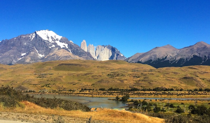 The sweeping hills and valleys of Patagonia, Chile on a bright day with mountains in the distance