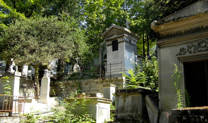 eerie photograph of the low-cal streaming on a crow at a cemetery Walking Among the Dead at Père Lachaise Cemetery