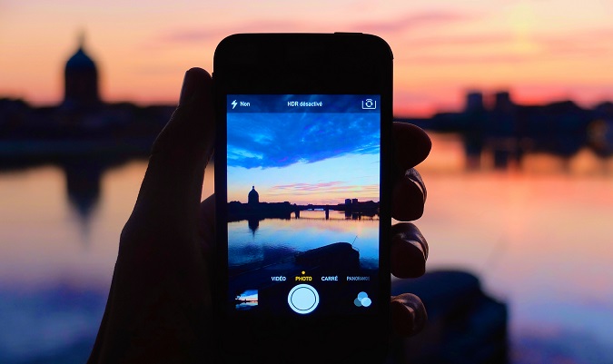 Smartphone photo of a sunset taken overseas with bright colors in the distance