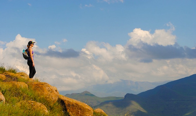 A solo female nomadic backpacker hiking in the dry hills of South Africa