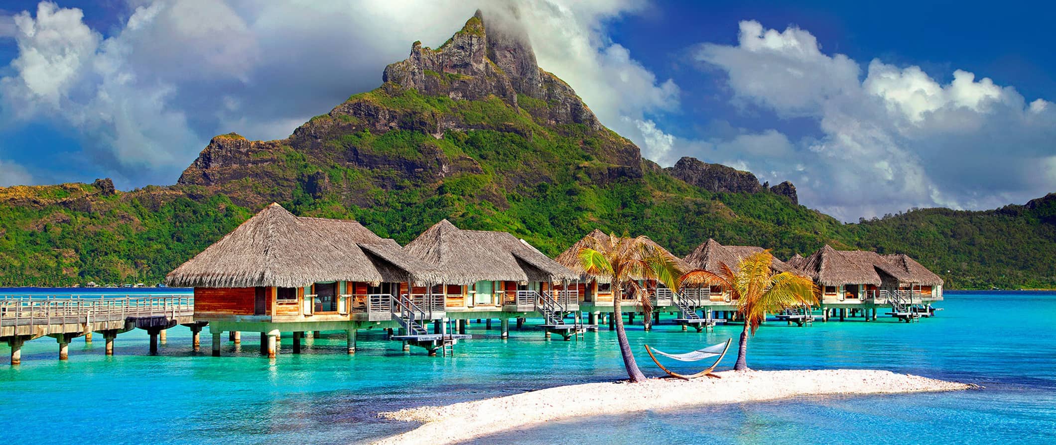 Overwater bungalows and clear waters at a picturesque beach in beautiful French Polynesia