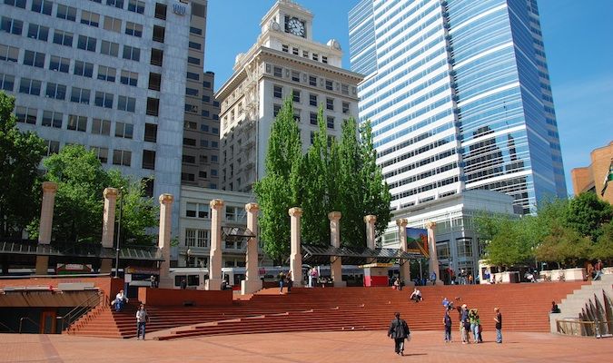 A sunny public plaza in Portland, Oregon with people walking around