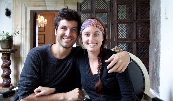 Elise and Anthony from Positive World travel posing for a photo at a table