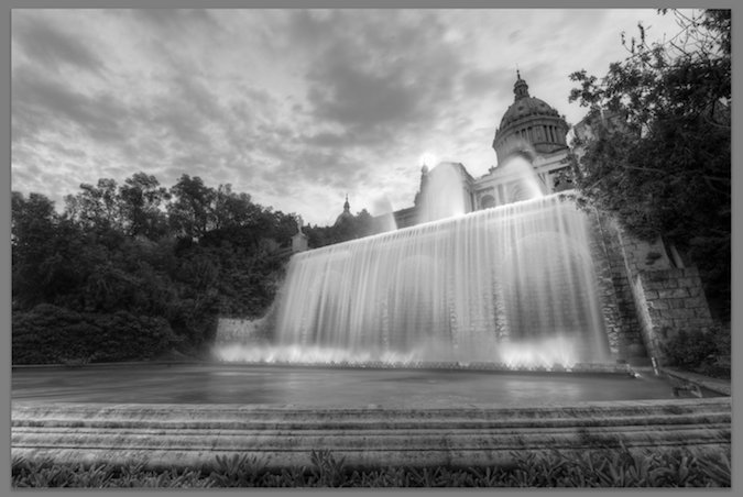 Photo of orange building and waterfall - black and white - desaturated