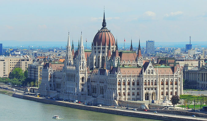 the massive Budapest parliament building on a sunny day