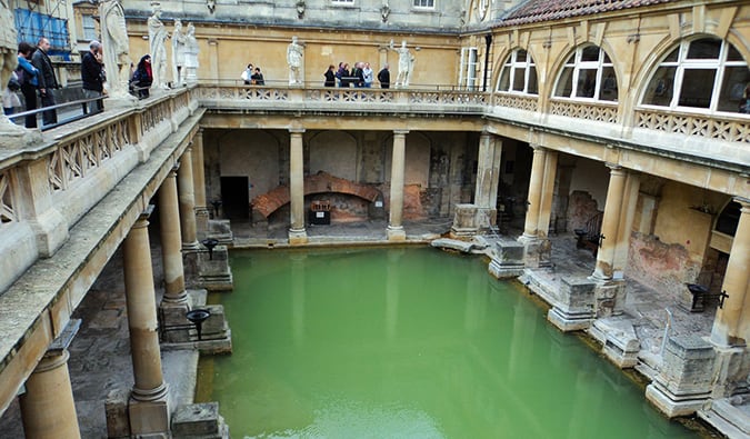 People hanging around the Roman Baths in Bath, England.