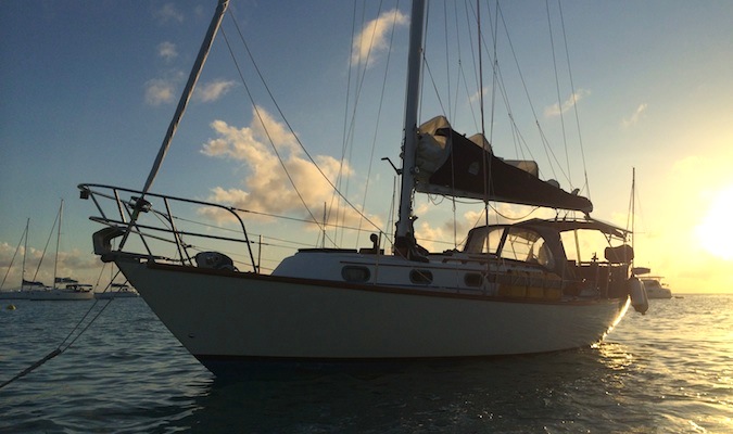 a sailboat anchored in the Virgin Islands at sunset