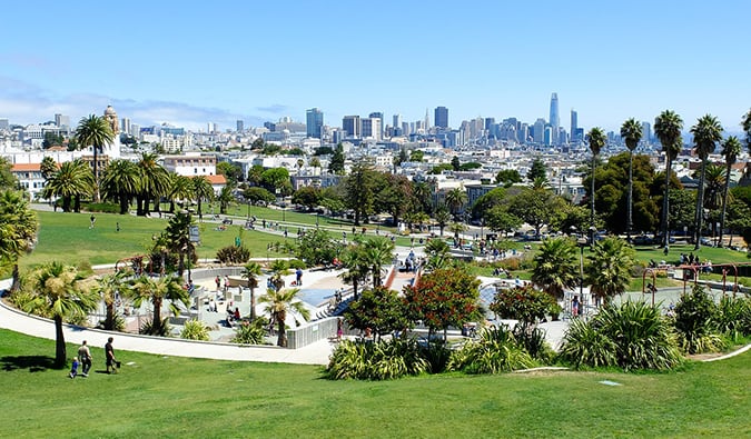 Groups of people hanging out on the lawn in the Mission District on a nice day in sunny San Francisco