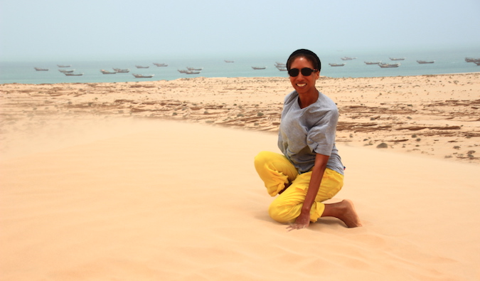 An expat teacher in Saudi Arabia posing on sand dune