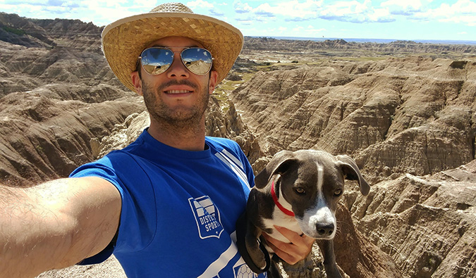 Scott Keyes from Scott's Cheap Flights posing with his dog