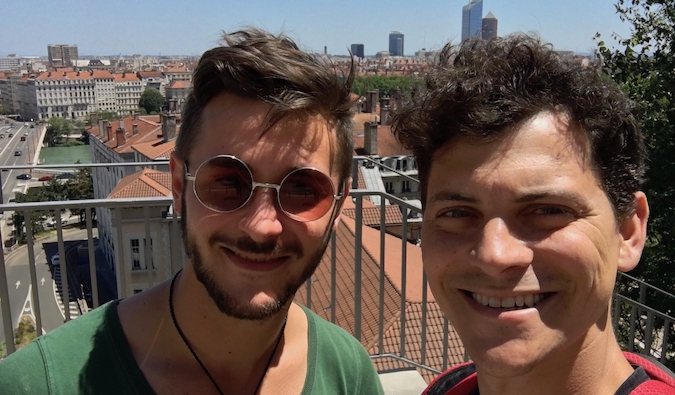 Nomadic Matt posing for a photo with his Couchsurfing host in France