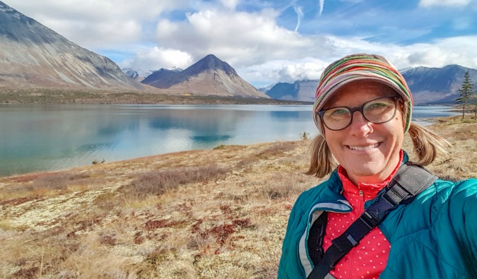 Sherry Ott standing in front of picturesque mountains