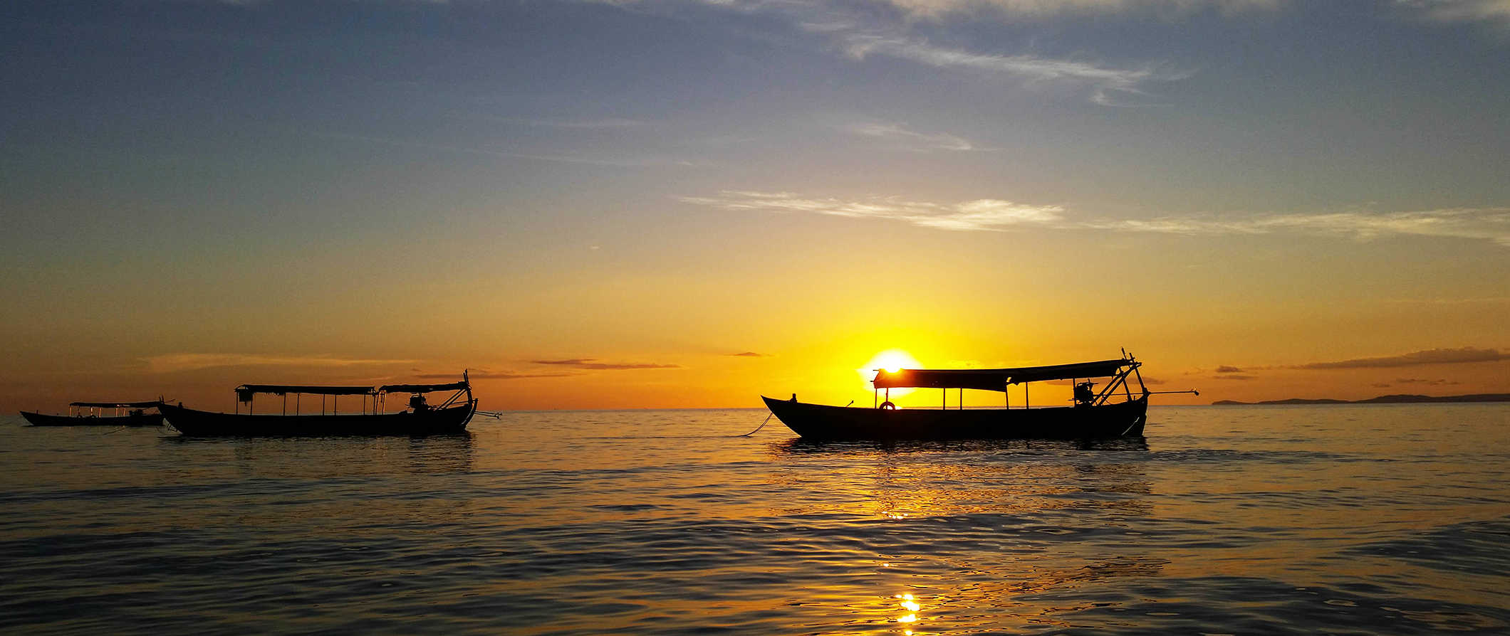 Small boats on the calm waters at sunset in Sihanoukville, Cambodia