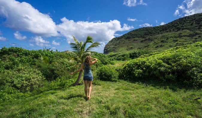 Solo female hiking in a lush green jungle