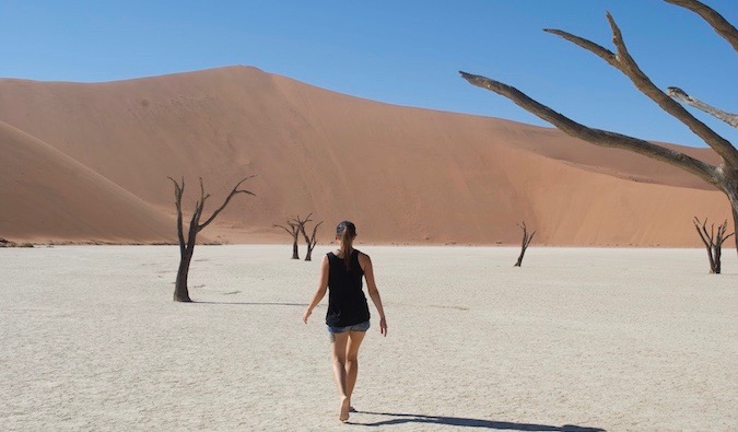 Solo female traveler walking alone in the desert of Namibia