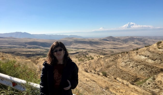 Staci standing near a large mountain