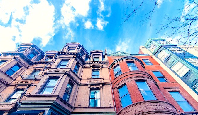 A set of colorful apartment buildings and a bright blue sky