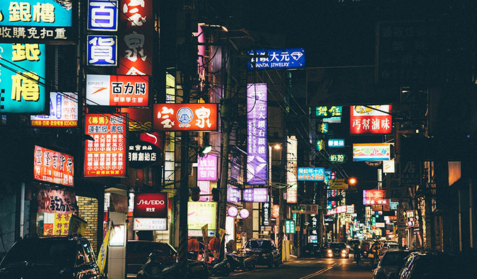 The busy streets of China lit up by signs at night