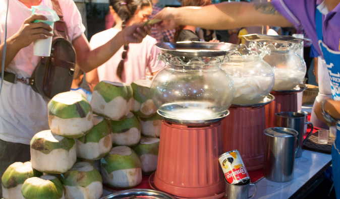 thailand's coconut drink and fresh coconuts sold on the streets