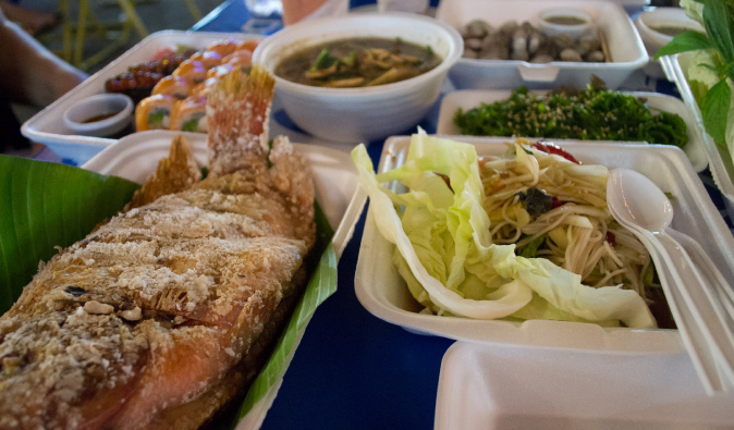 fried fish, noodles, pad thai and other thai street food, dinner at the market in Bangkok