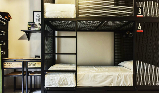 Black metal bunk bed and desk at the YellowSquare hostel in Rome, Italy