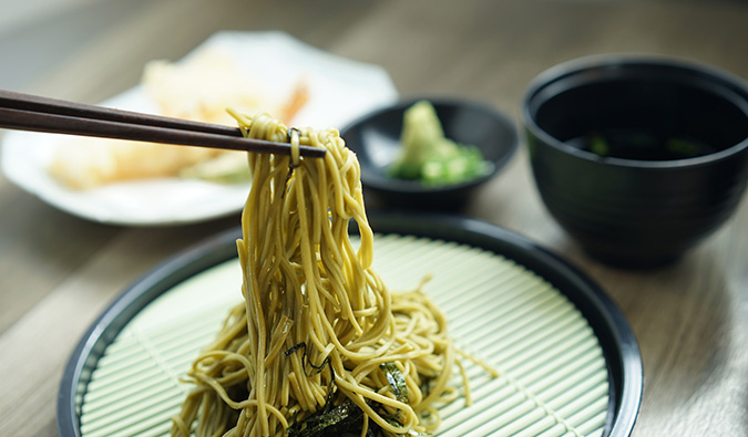 chopsticks and a bowl of noodles