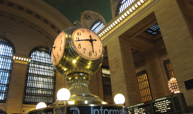 A huge clock in a large train station