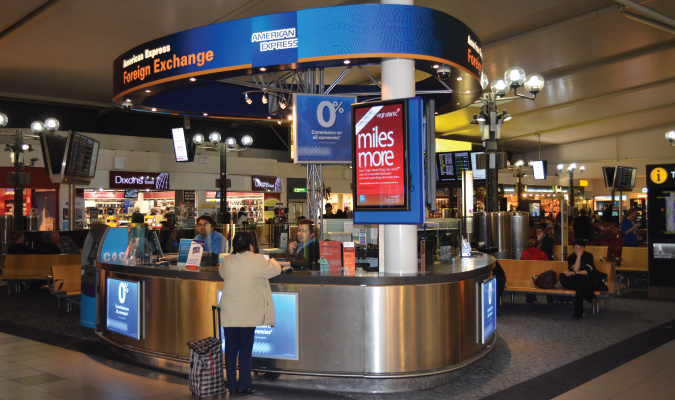 A busy currency exchange kiosk in an airport