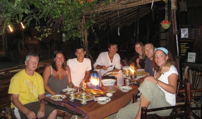 Traveling friends eating together at a hostel in Thailand