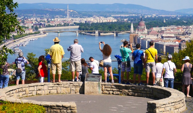 Tourists taking pictures overlooking a city in Europe