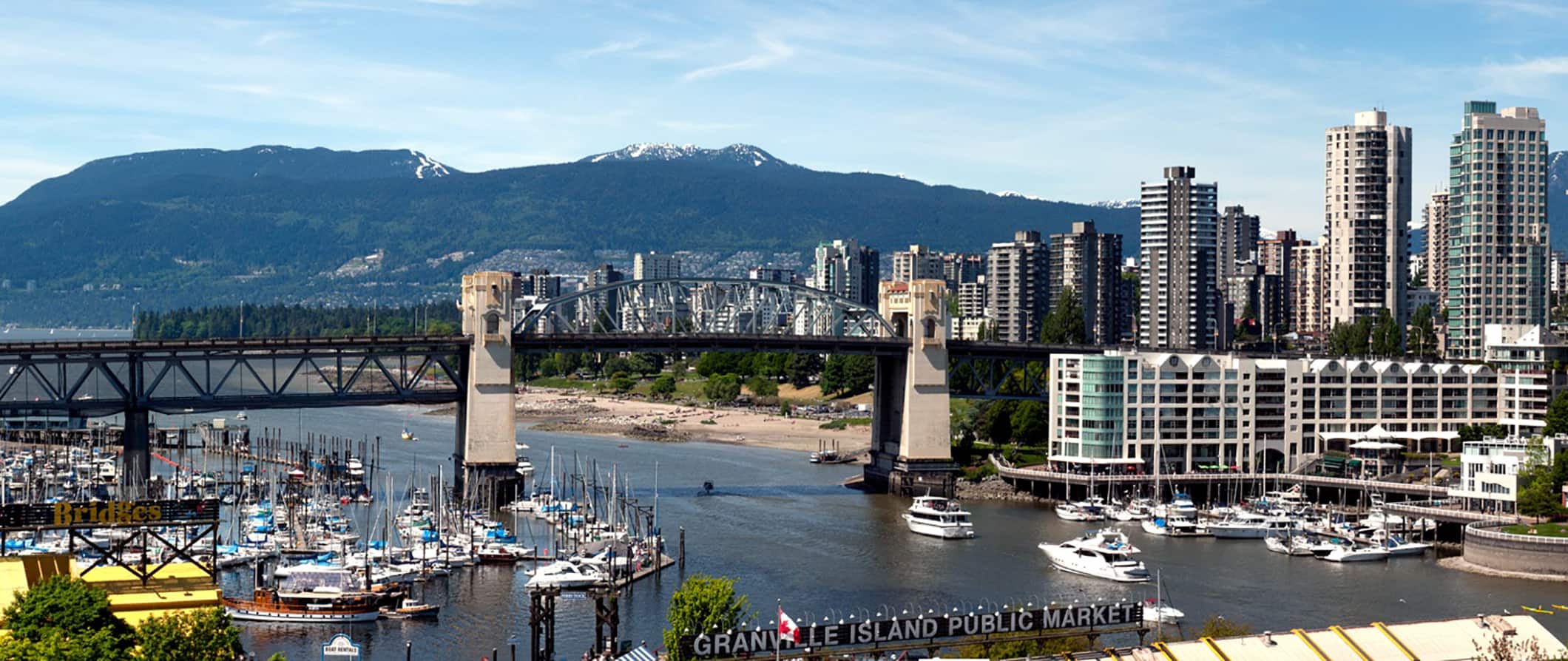 The towering Vancouver, Canada skyline near the coast on a sunny summer day