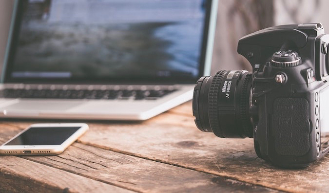 a laptop and camera on a table