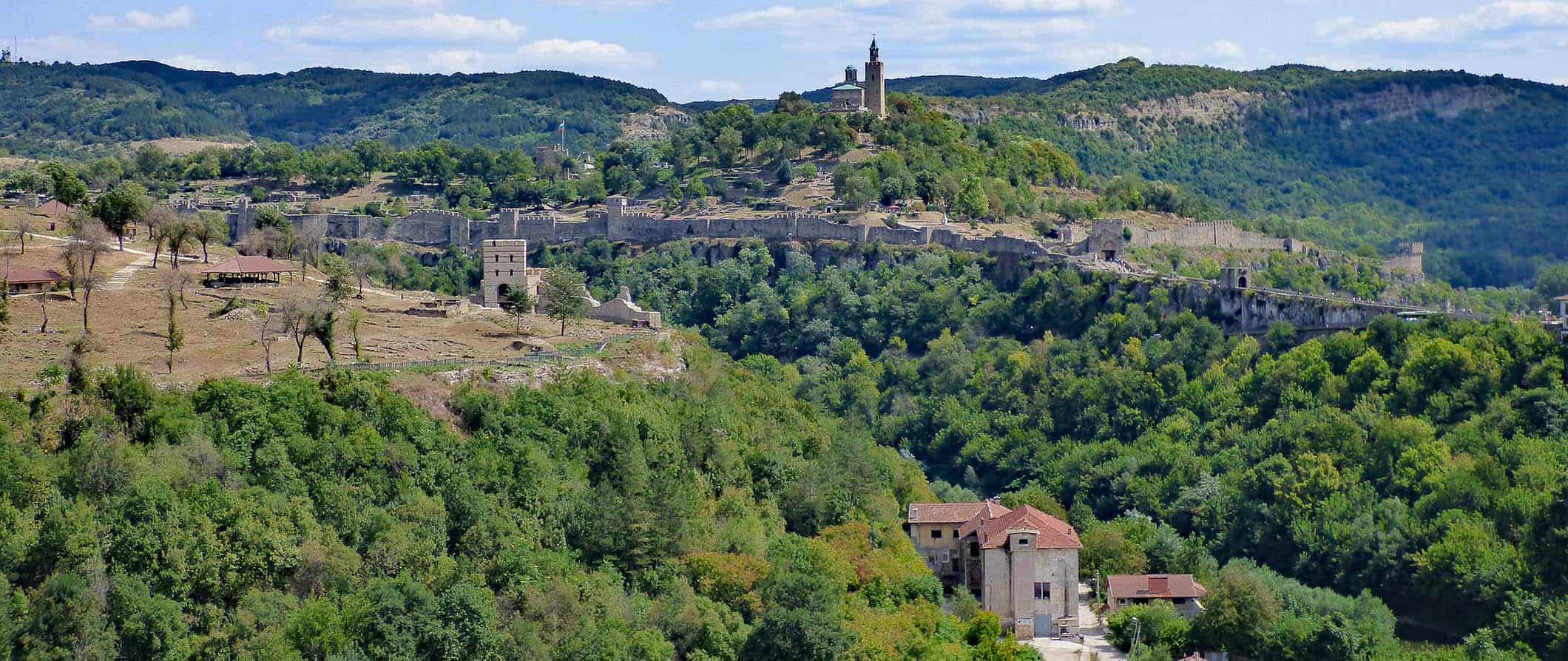 The historic fortress overlooking Veliko Tarnovo, Bulgaria surrounded by trees and hills