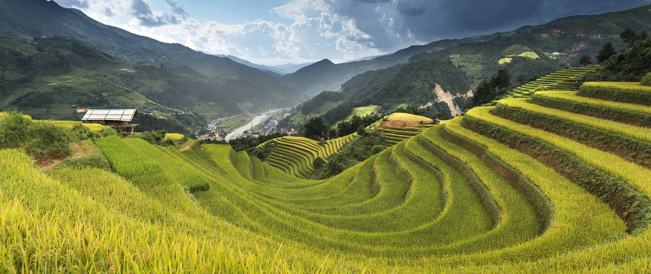 Rice terraces in Vietnam surrounded by list hills and mountains on a sunny day