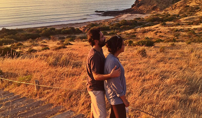 Vikram and Ishwinder from Empty Rusacks standing together near the coast at sunset