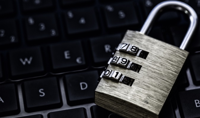 A padlock resting on top of a laptop keyboard