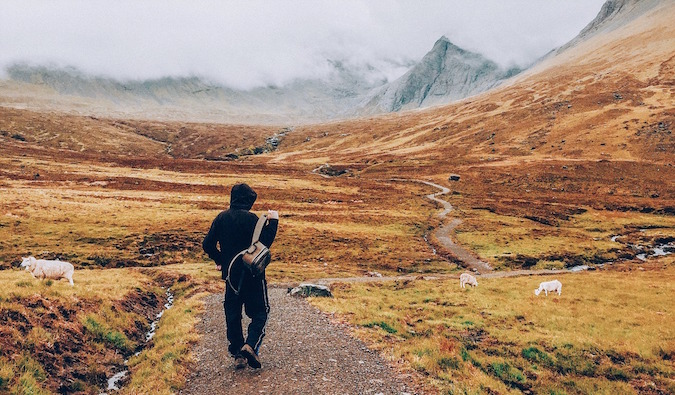 A solo traveler setting out on a hike in the hills and mountains