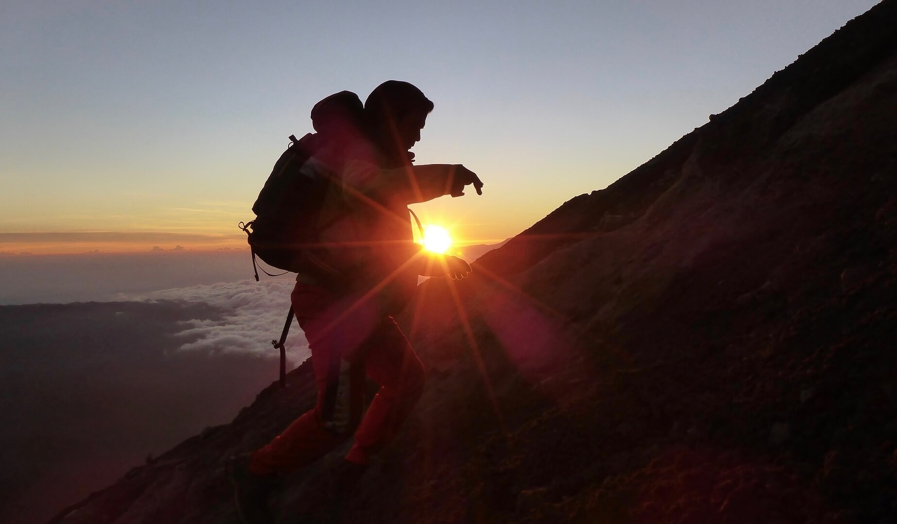 man climbing a mountain